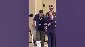 [EN] A touching humanitarian gesture by President Sisi by carrying the “crutch” of one of the injured policemen during the Eid al-Fitr celebration
